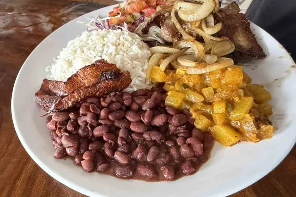 Casado mit Reis, schwarzen Bohnen, gebratener Kochbanane, Kohlsalat, Fleisch und Zwiebeln